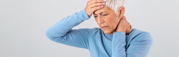 Patient holding head and neck